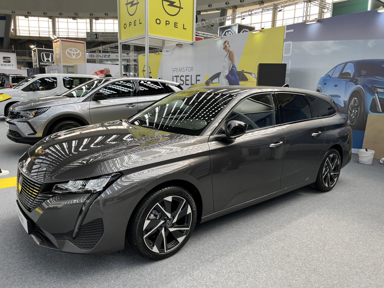 Sleek station wagon silhouette with distinctive multi-spoke alloy wheels
