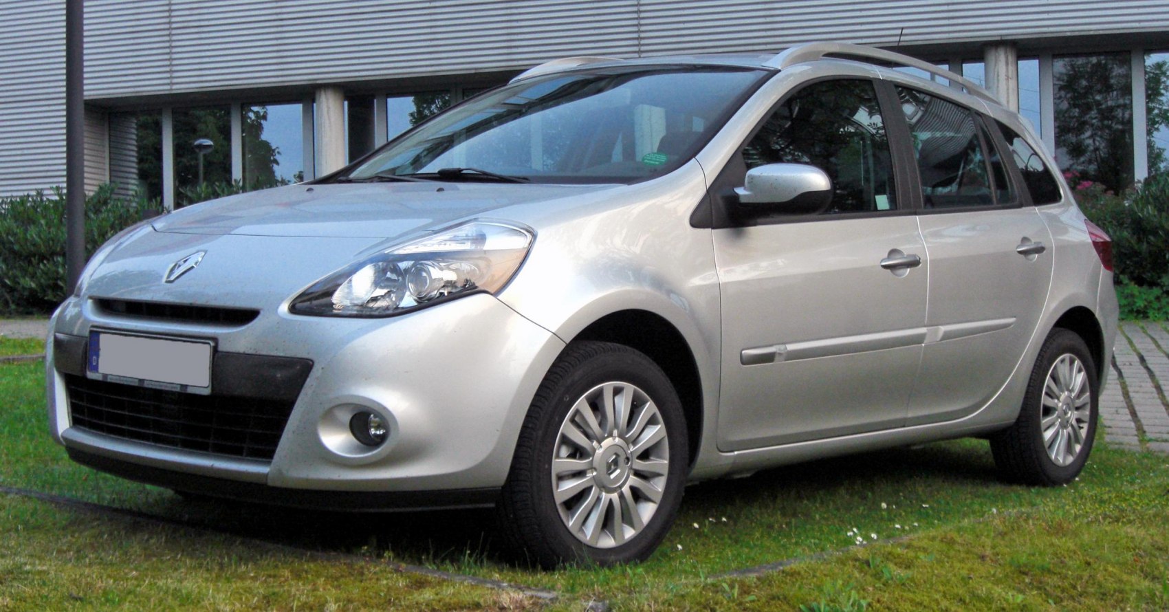 Compact wagon with roof rails, rounded headlights, and alloy wheels