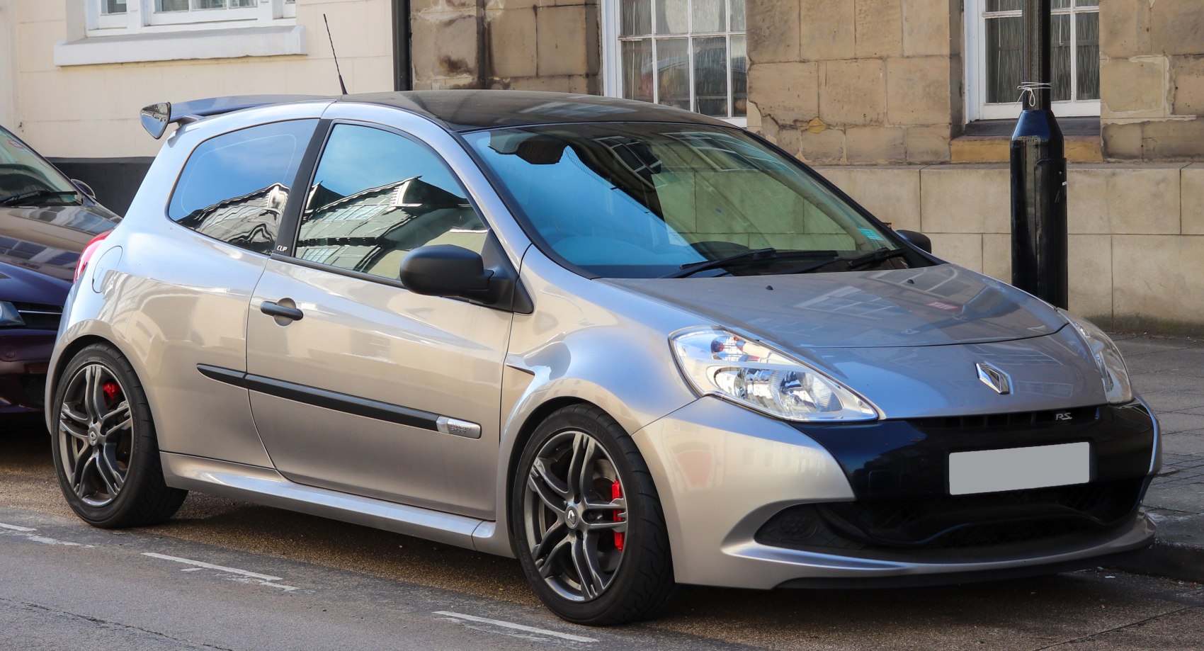 Sporty 3-door hatchback with black wheels and red brake calipers
