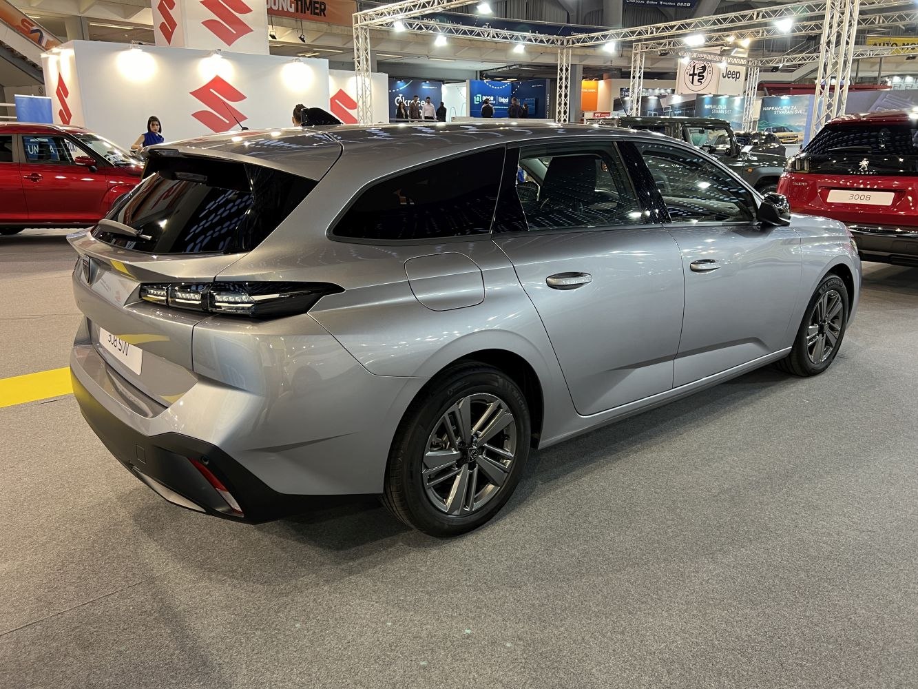 Silver station wagon rear side with sleek lines and modern tail lights.