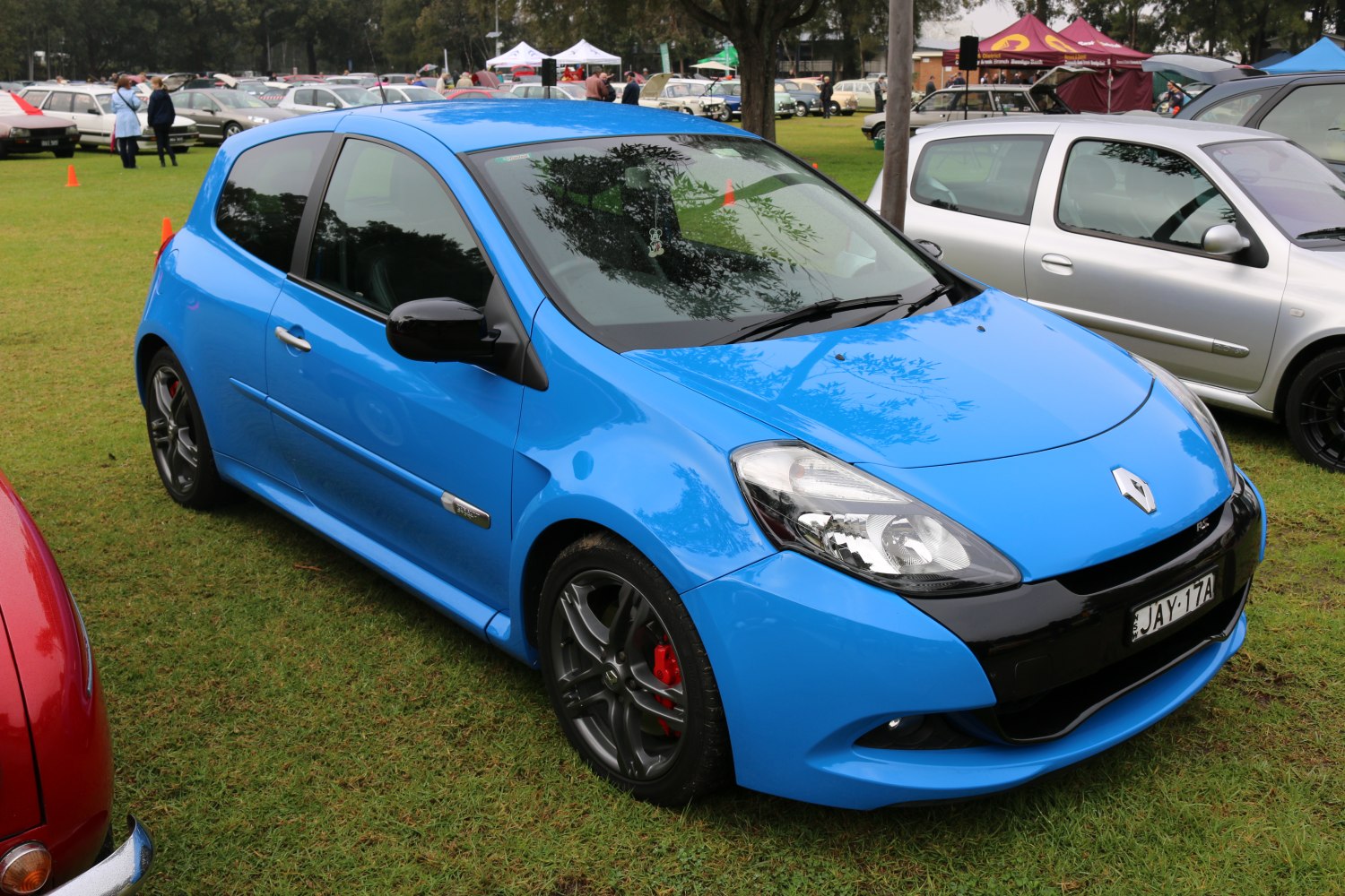 3-door blue hatchback with sporty alloy wheels and sleek headlights