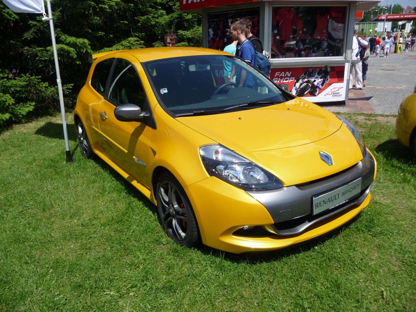 Yellow 3-door sporty hatchback with front headlights and alloy wheels