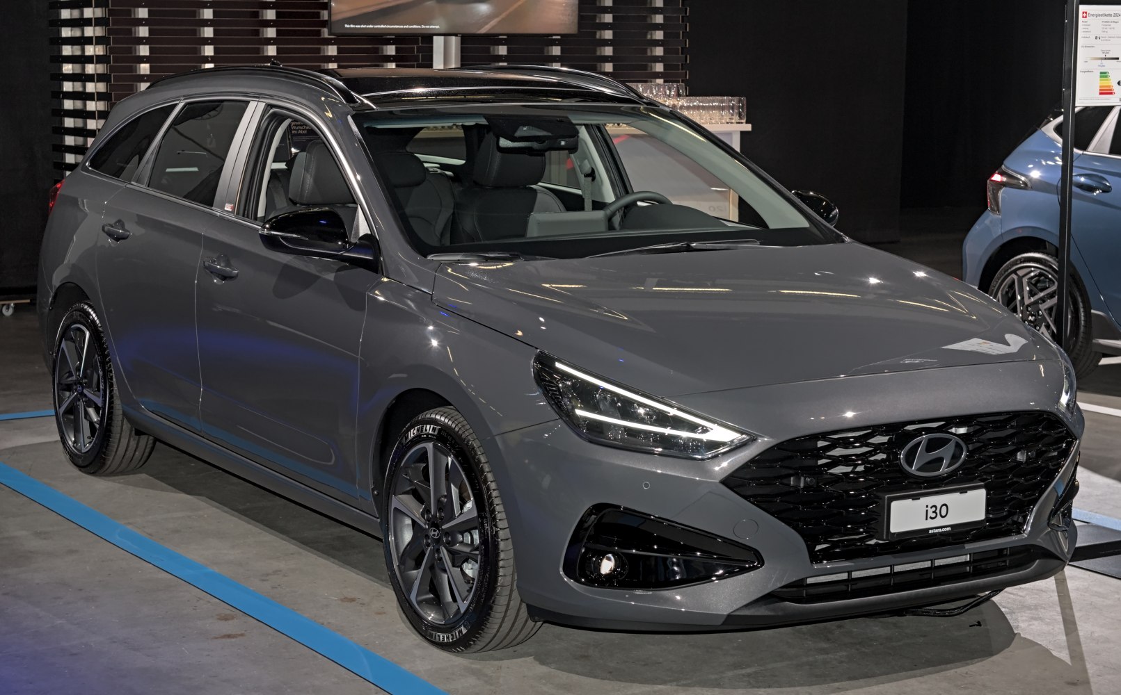 Sleek front view with modern grille and sporty alloy wheels
