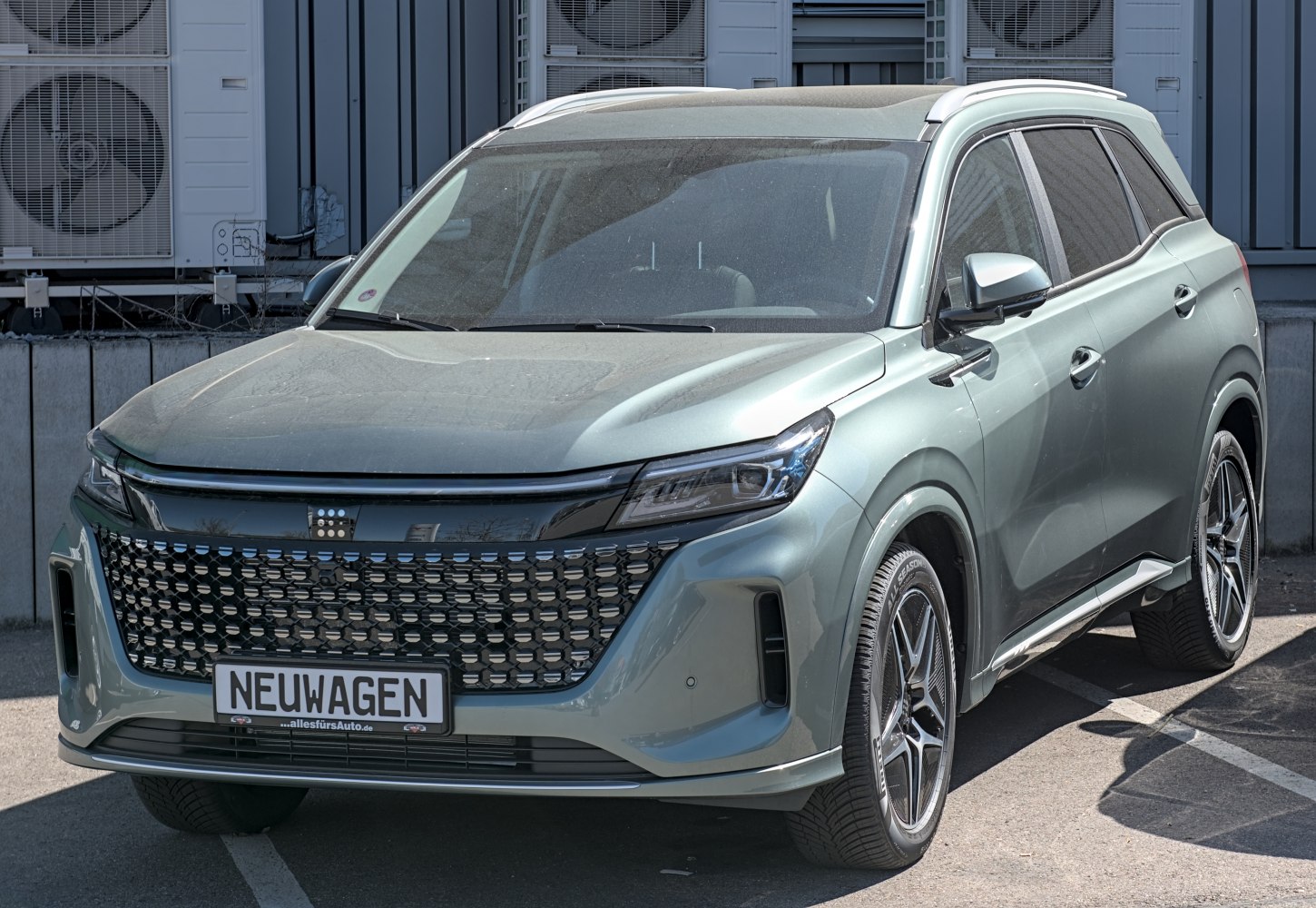Modern electric SUV front with LED headlights and bold grille