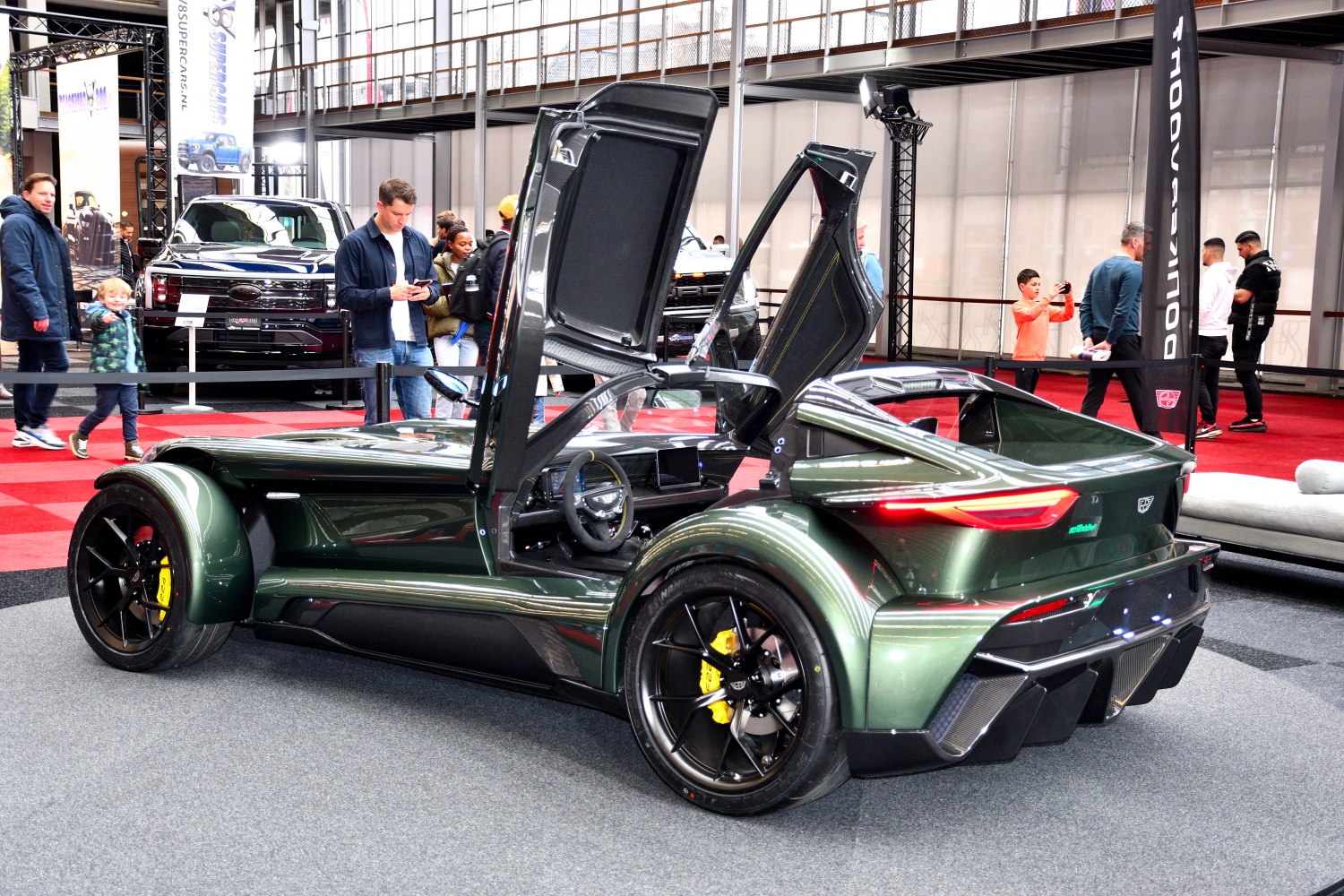 Gullwing doors and aerodynamic carbon-fiber body with black wheels and yellow brakes