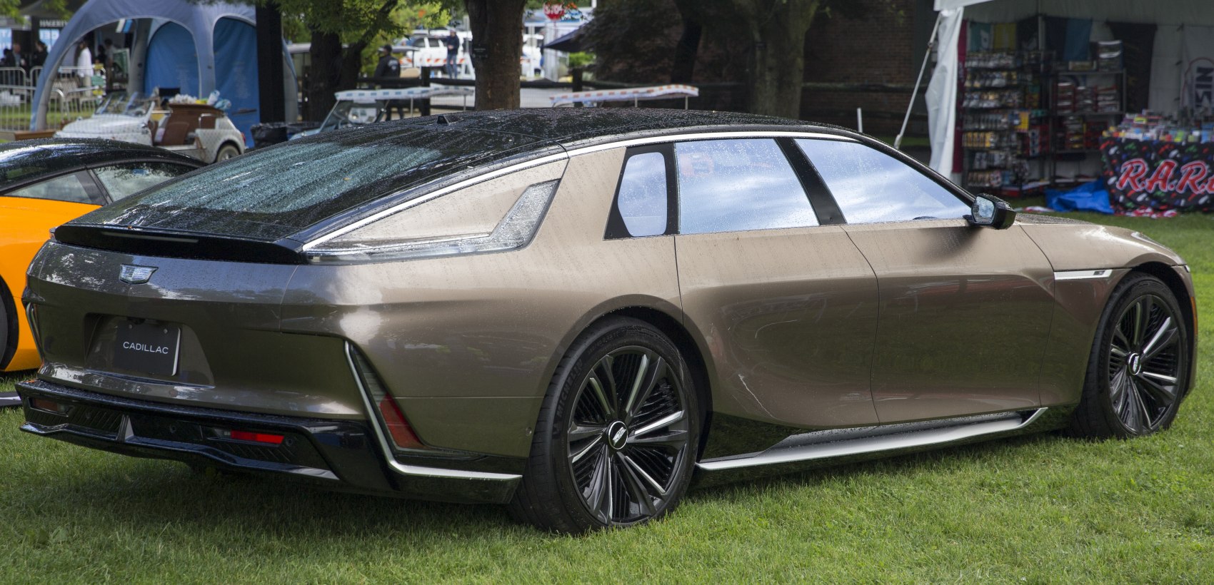 Rear design and side profile of a sleek luxury sedan with aerodynamic lines.
