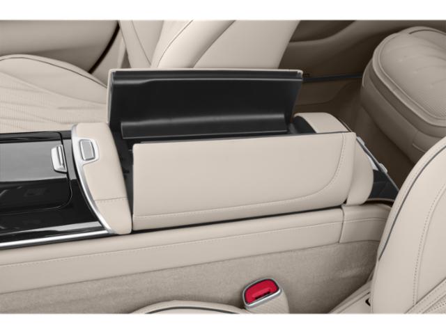 Beige leather seats and modern center console with open storage compartment