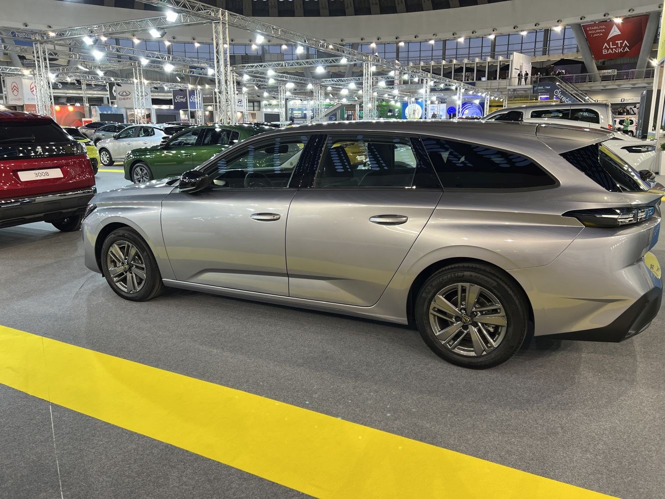 Side profile of a silver station wagon with alloy wheels.