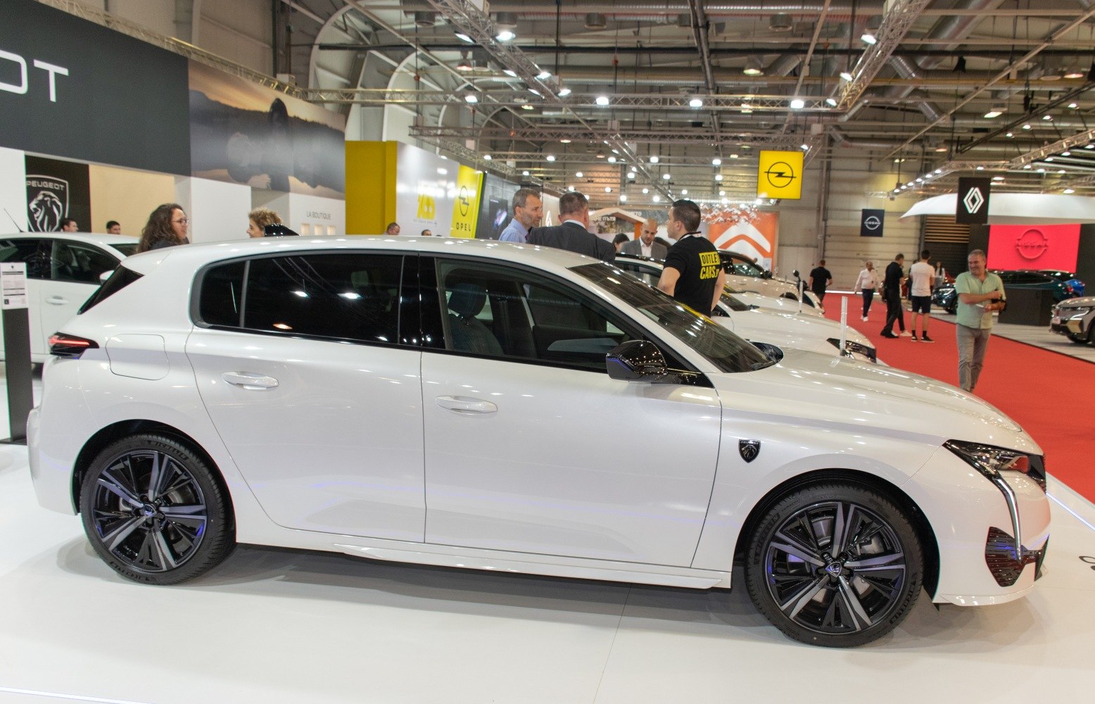White sports hatchback with distinctive LED headlights and alloy wheels