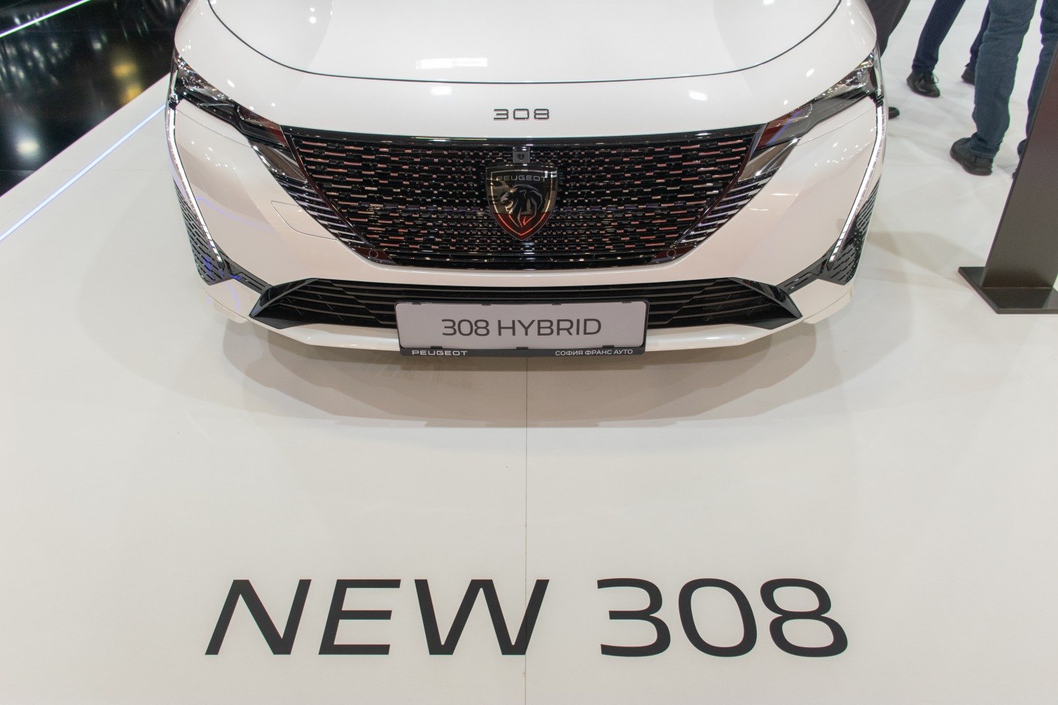 Close-up of front grille, Peugeot badge, LED headlights