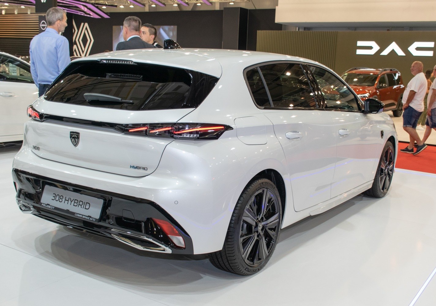 Rear view of a white hybrid hatchback with distinct taillights and aerodynamic design