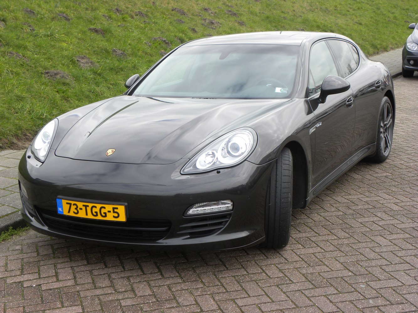 Front view of a luxury sedan with distinctive headlights and aerodynamic contours