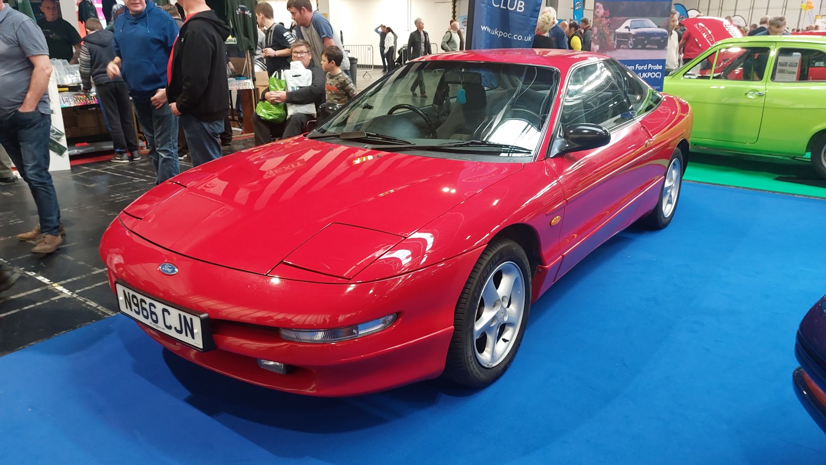 Red sports coupe with pop-up headlights and sleek aerodynamic design