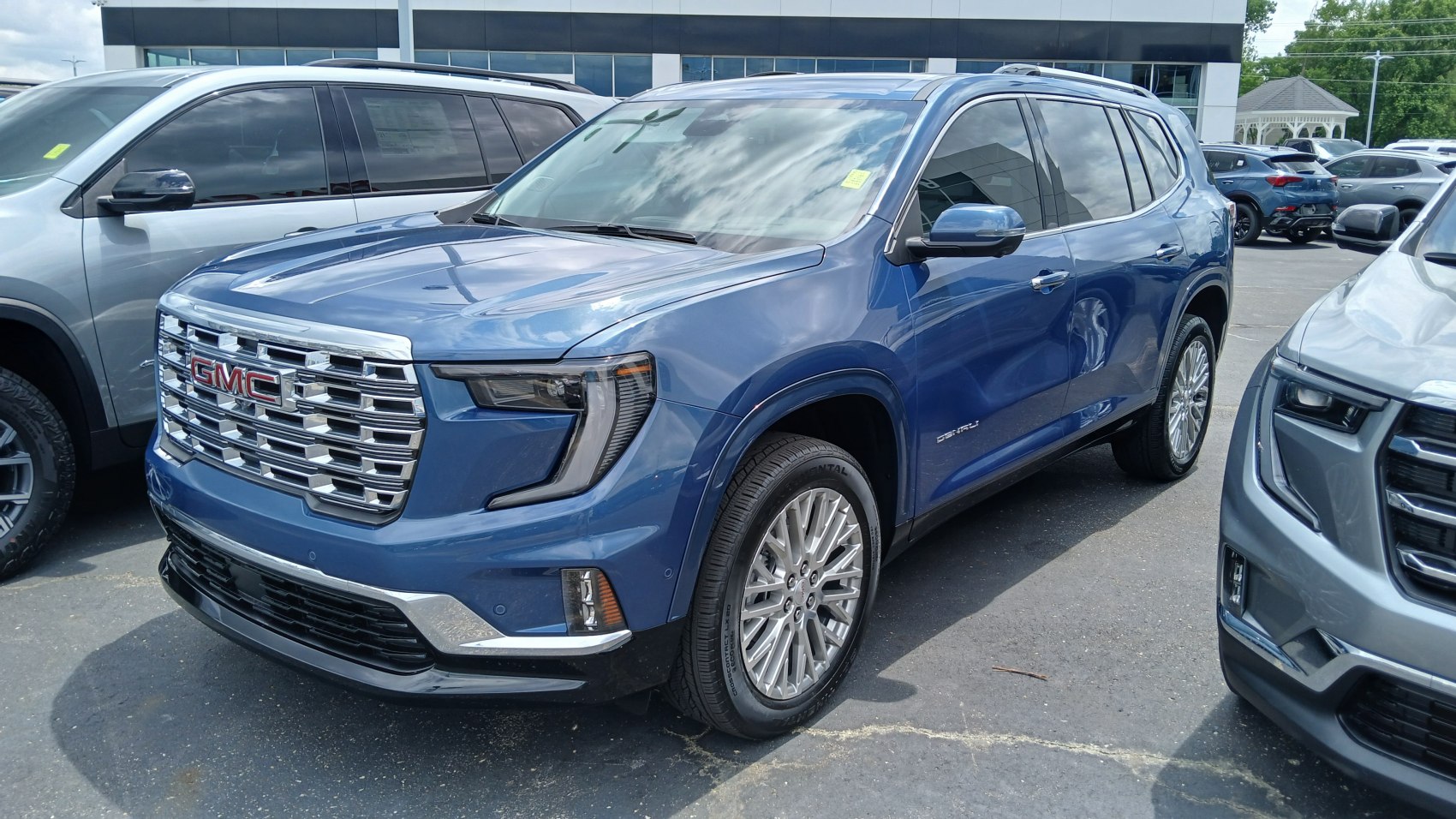 Front-side view of blue SUV with chrome grille and LED headlamps