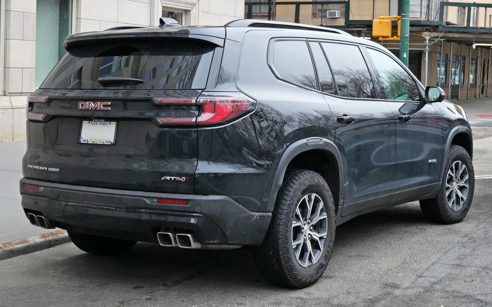 Rear and side view of SUV with quad exhausts and tinted windows