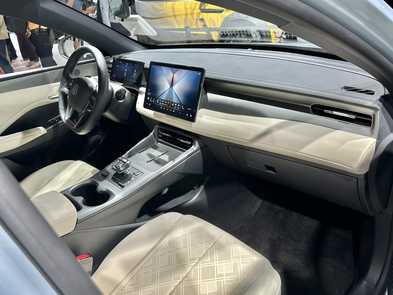 Dual digital displays and modern dashboard with beige seats