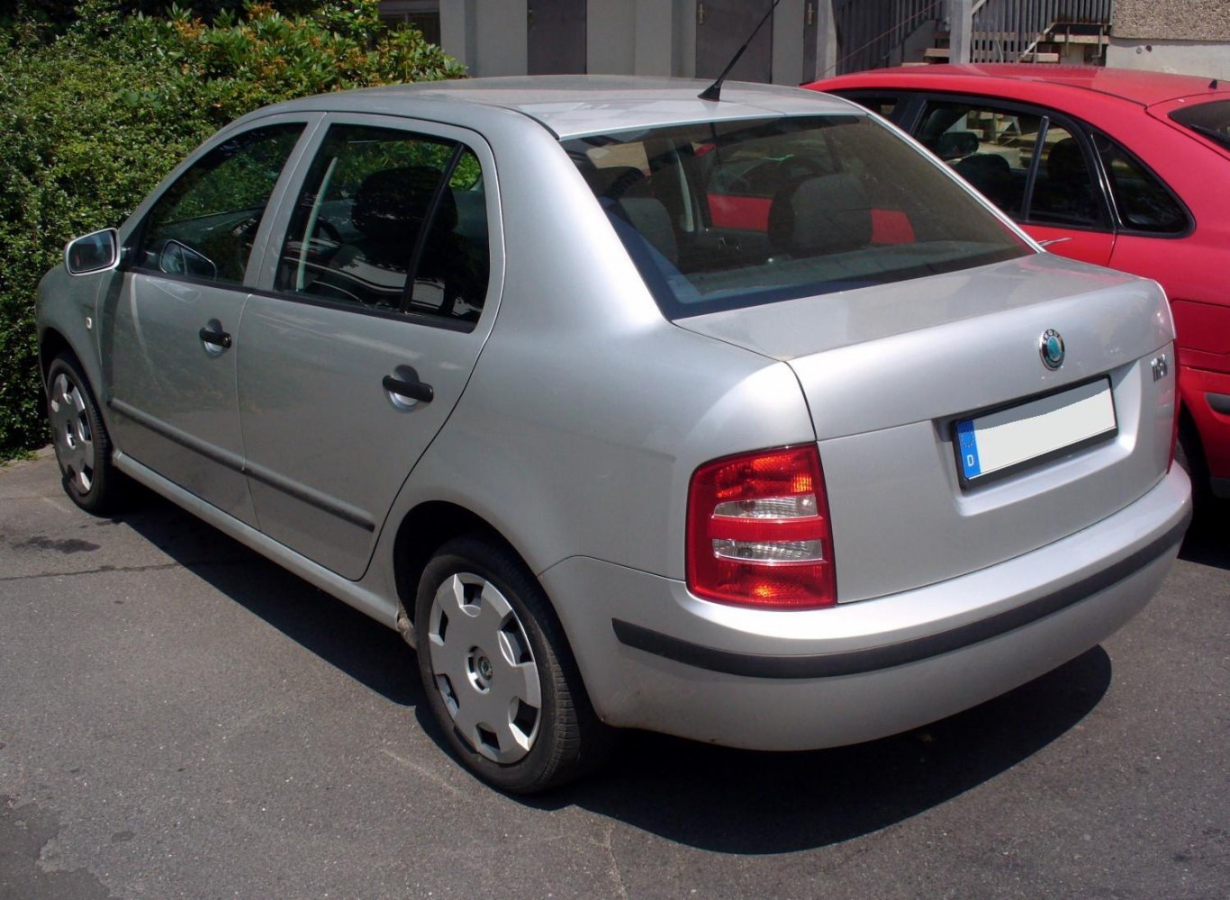 Silver compact sedan rear-side view with taillights and alloy wheels