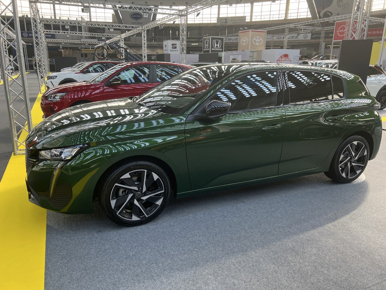 Sleek modern hatchback side profile with distinctive alloy wheels
