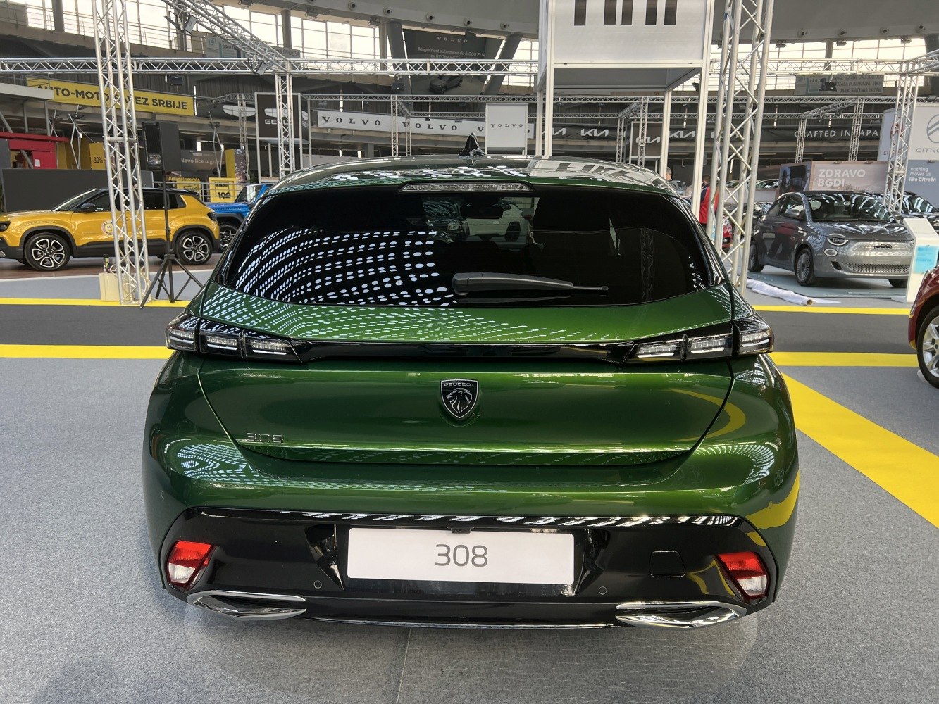 Green hatchback rear with sleek taillights and dual exhausts