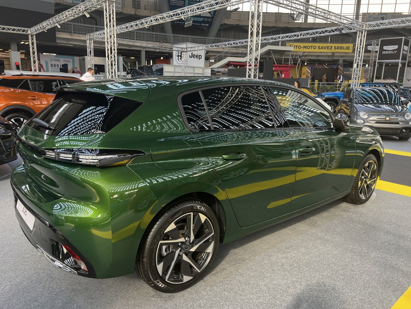 Rear and side view of modern hatchback with sleek taillights and alloy wheels.