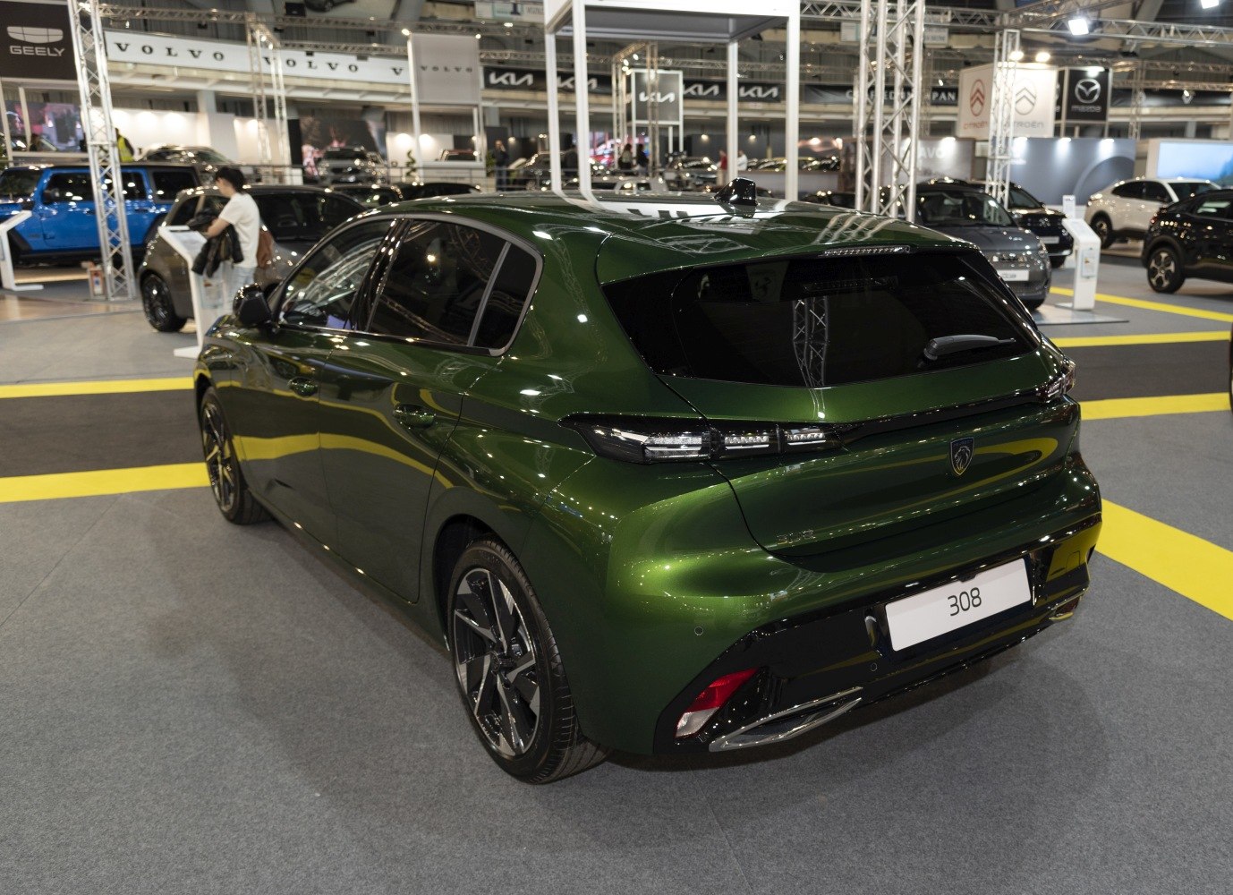 Rear and side view of a green hatchback with distinctive tail lights.