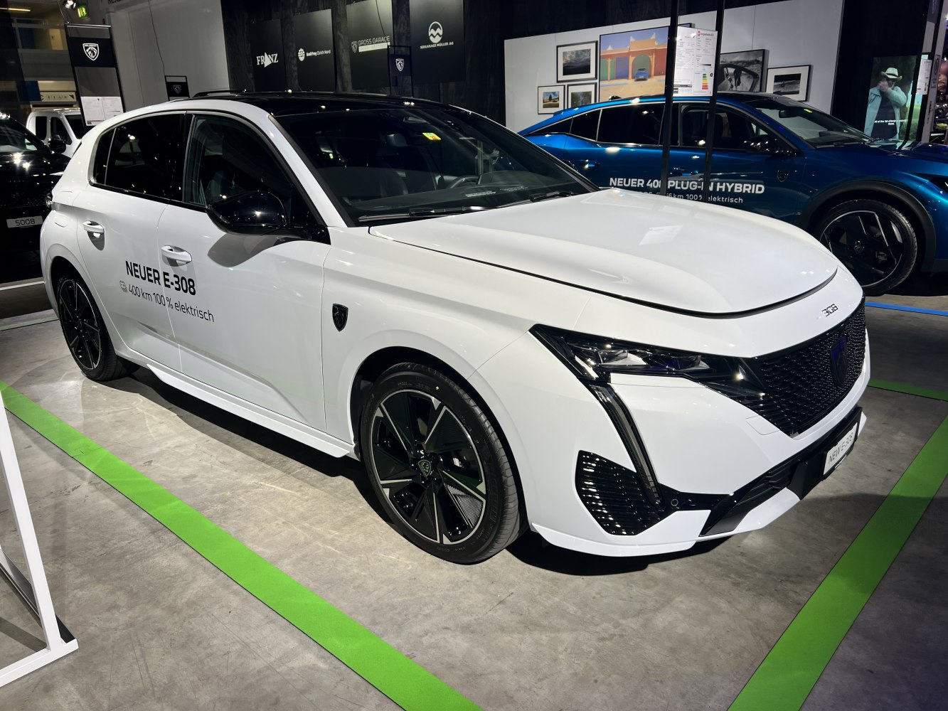 White electric hatchback with LED headlights and black wheels