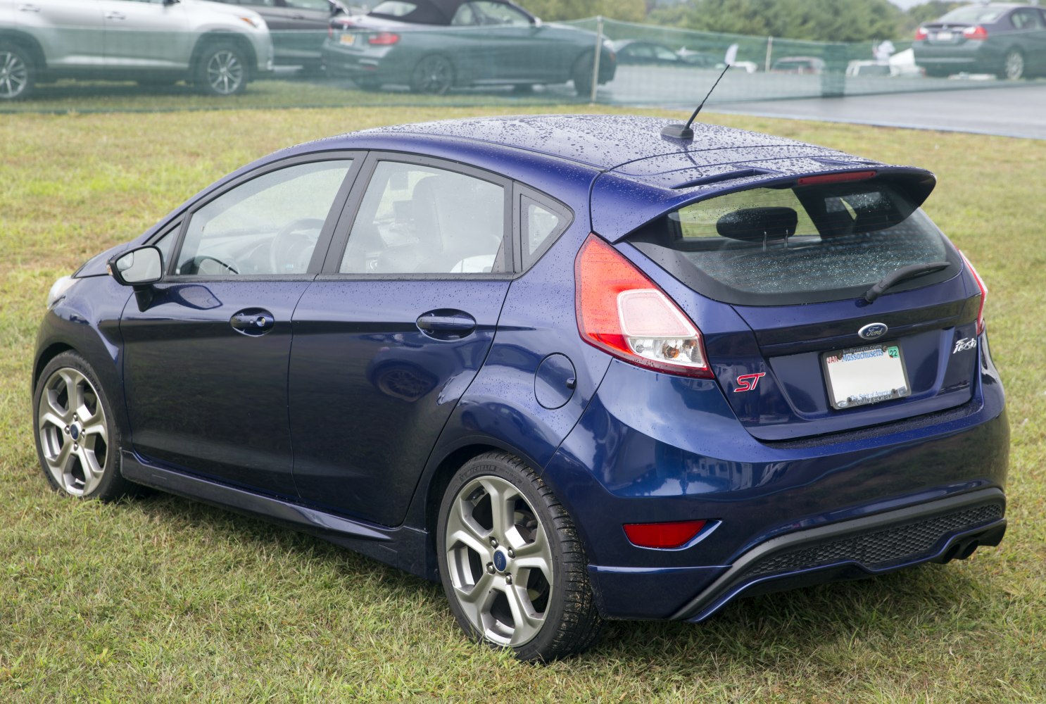 Rear view of sporty hatchback with distinctive taillights and alloy wheels.