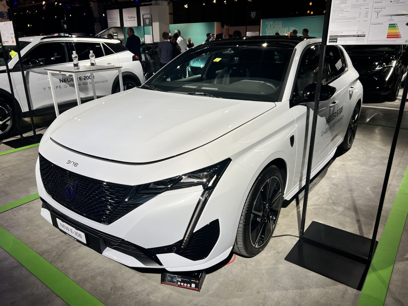 Front view of white hatchback with black grille and LED headlights