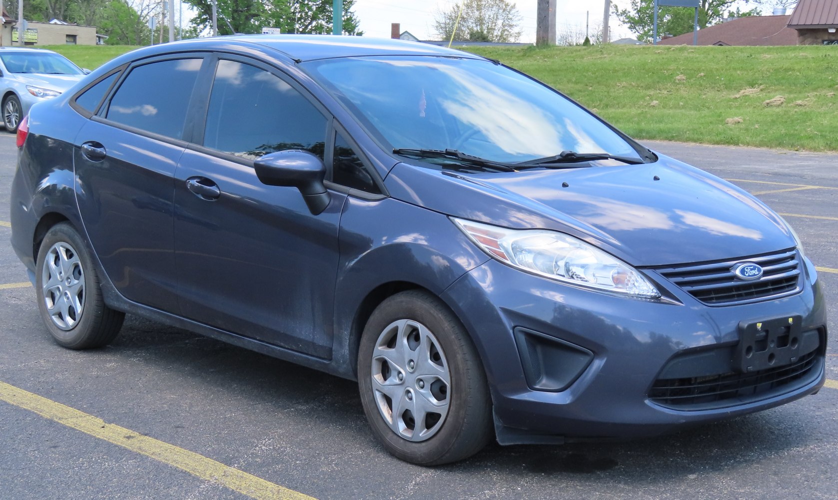 Compact sedan with sleek headlights and distinctive front grille