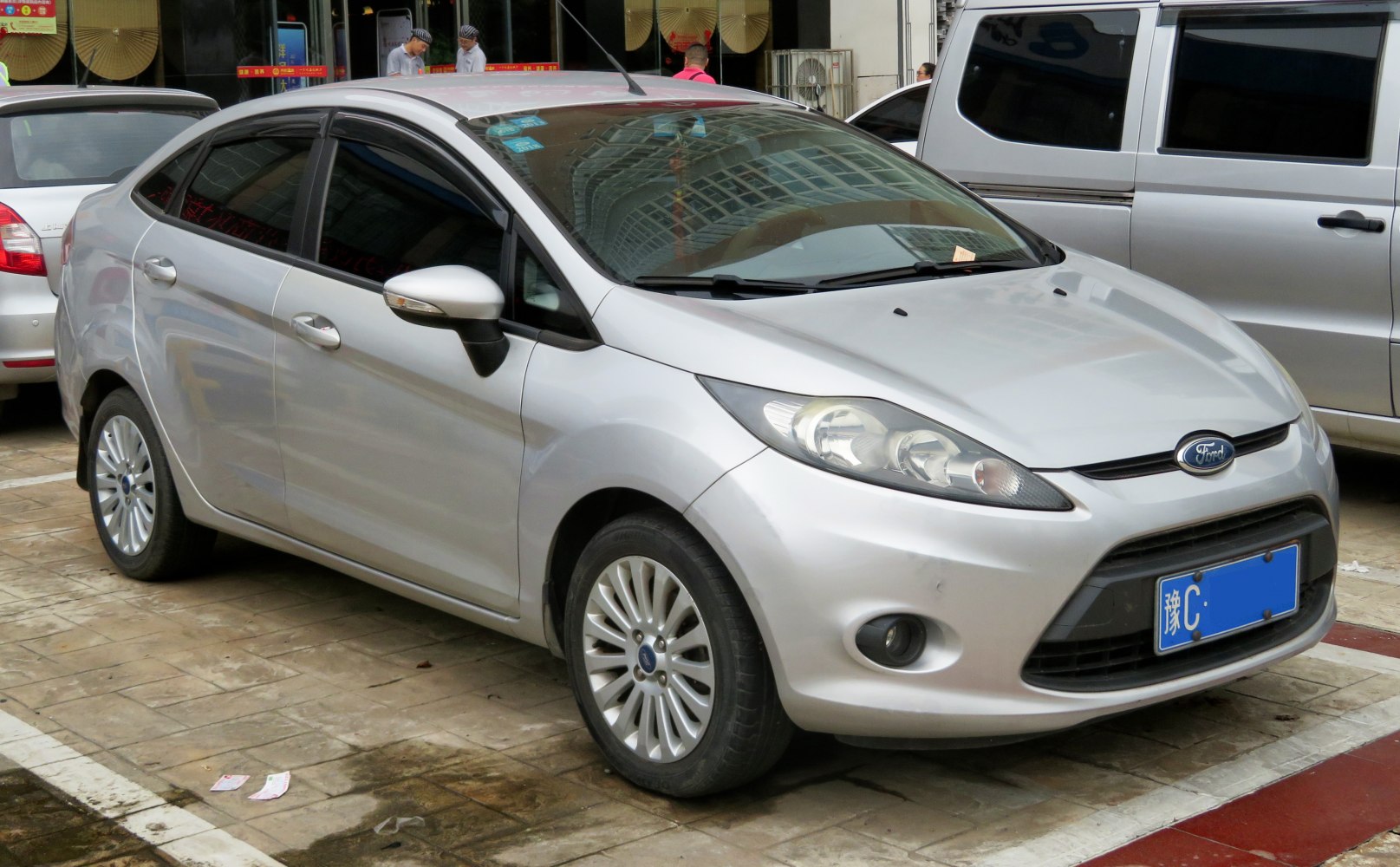 Compact silver sedan with aerodynamic front and alloy wheels