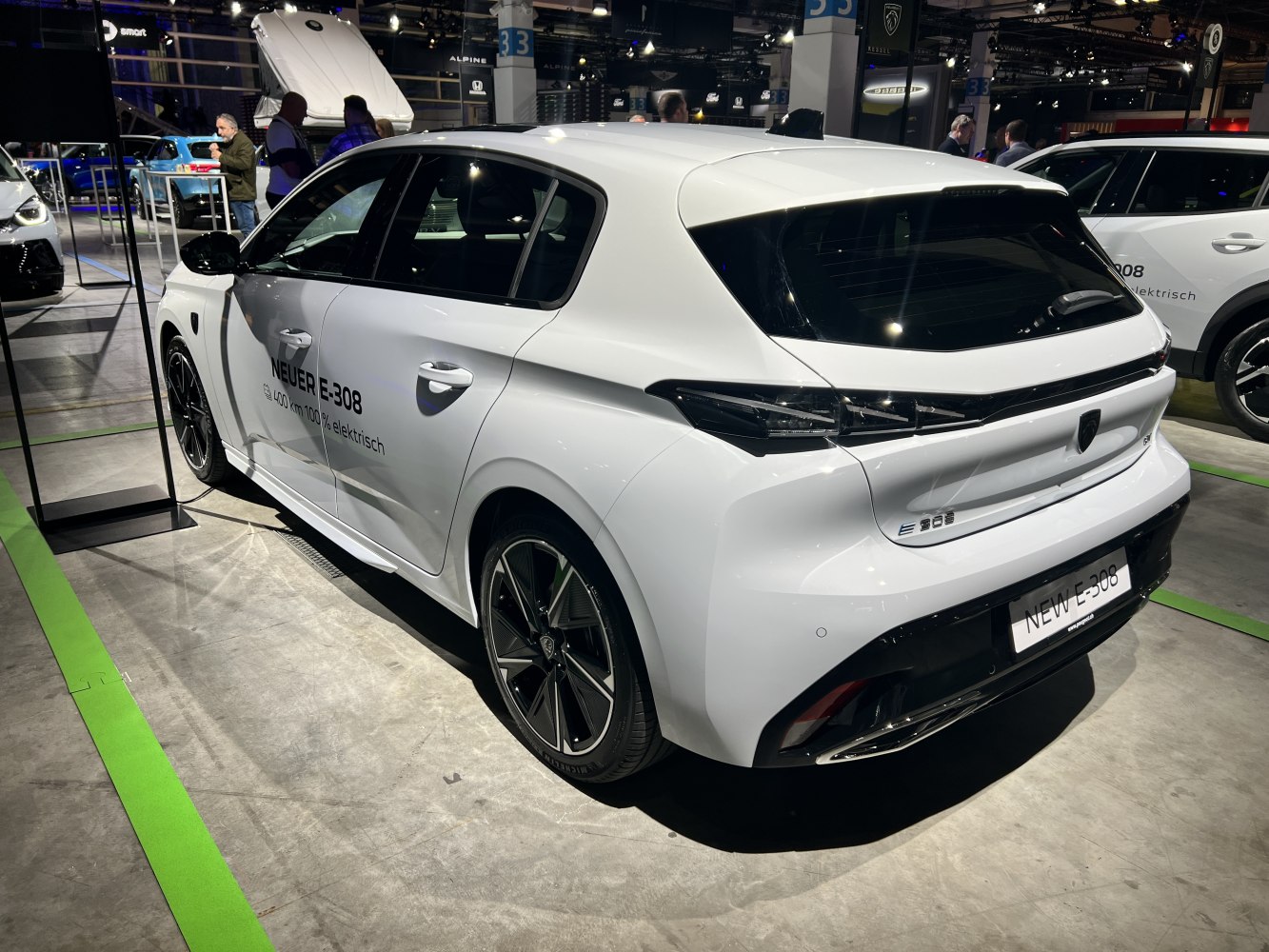 Aerodynamic rear and side view of an electric hatchback with alloy wheels.