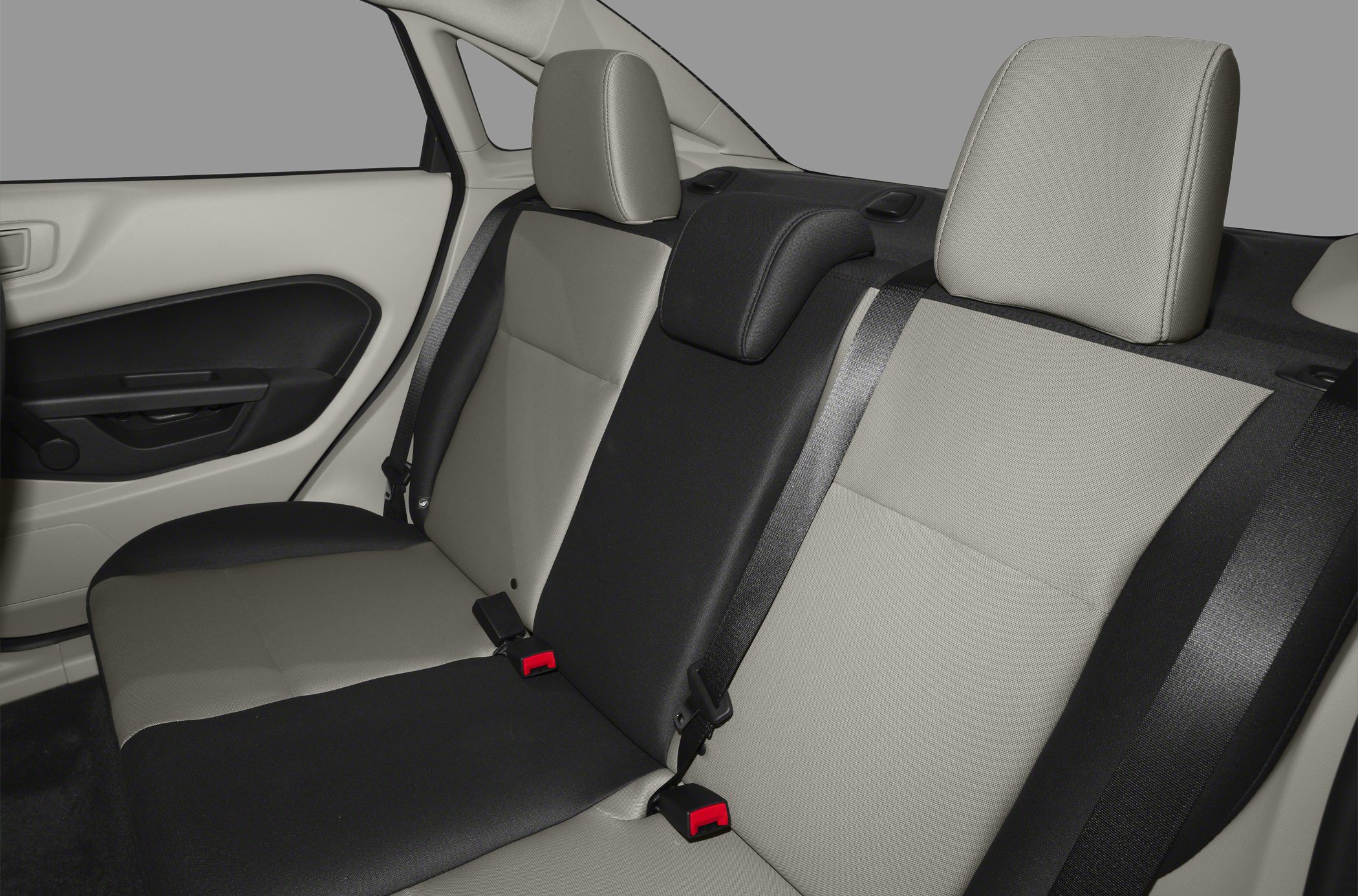 Two-tone rear sedan seats with headrests and seat belts