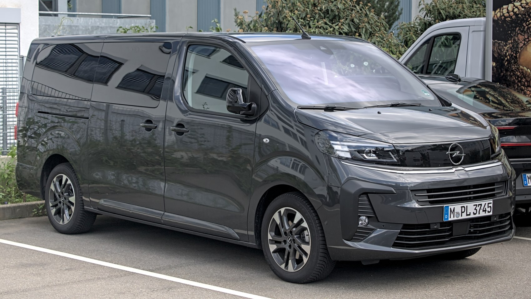 Front and side view of a sleek modern minivan with tinted windows and alloy wheels