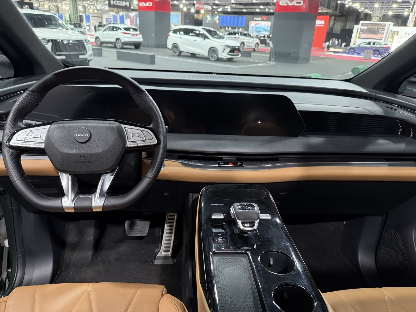 Digital dashboard with tan leather seats and modern steering wheel