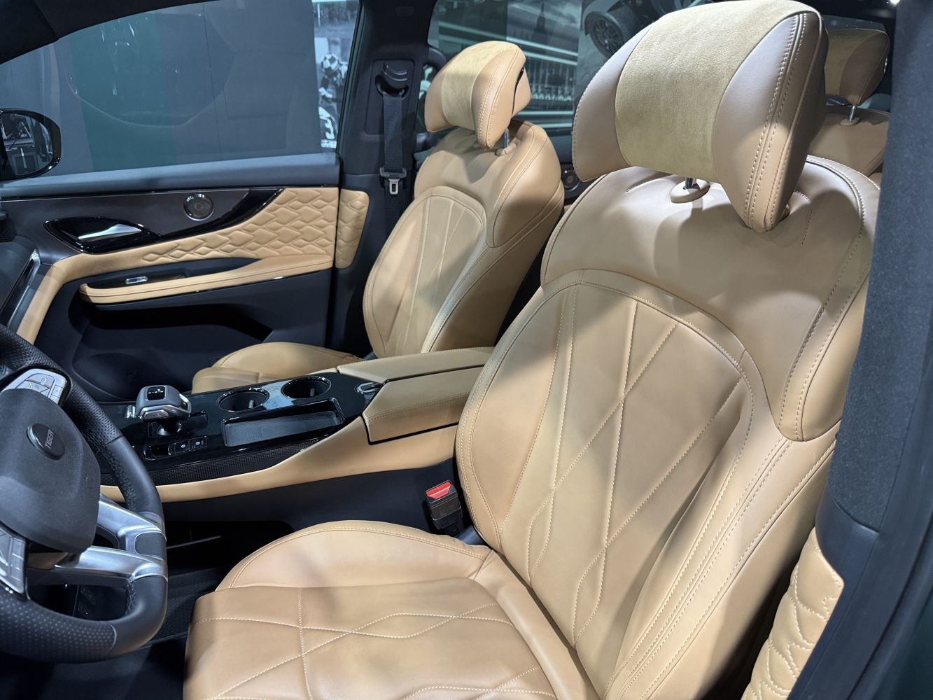 Beige leather front seats with detailed stitching and modern center console