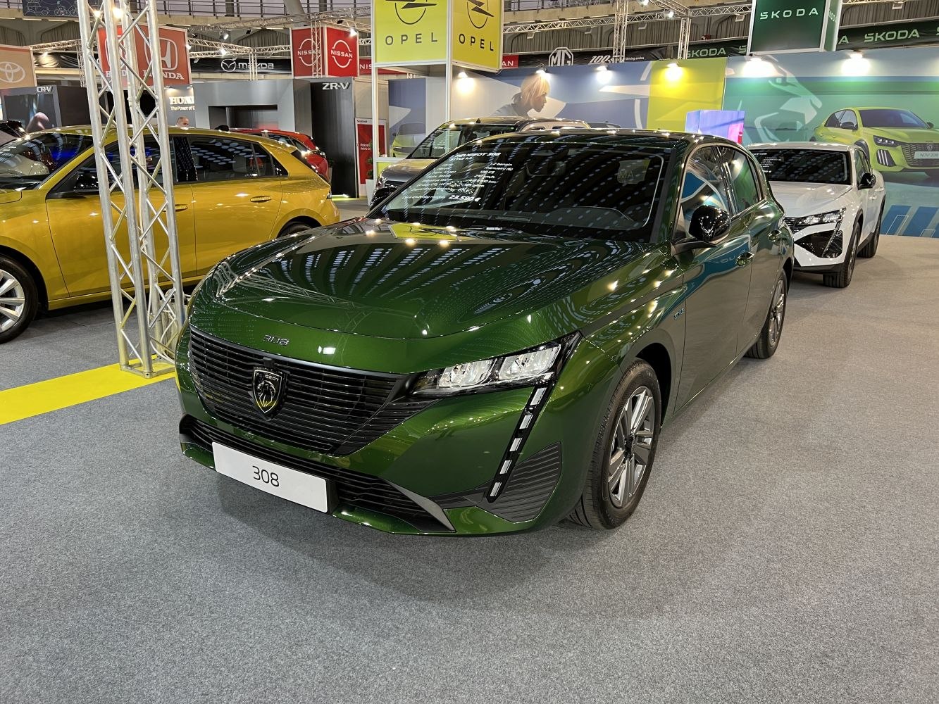 Front view of green hatchback with LED headlights and black grille