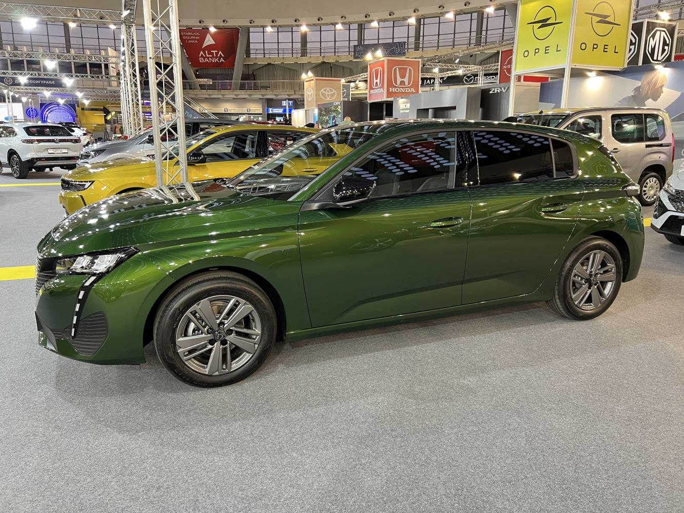 Green compact hatchback with LED headlights and alloy wheels
