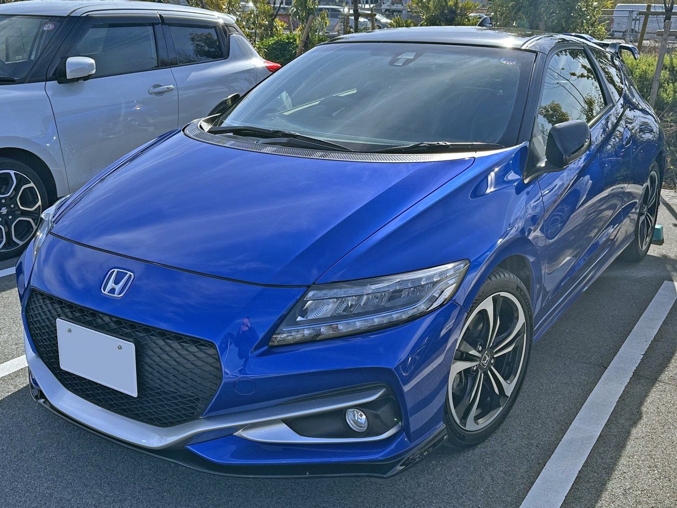 Front and side view of a sporty hatchback with LED headlights and alloy wheels