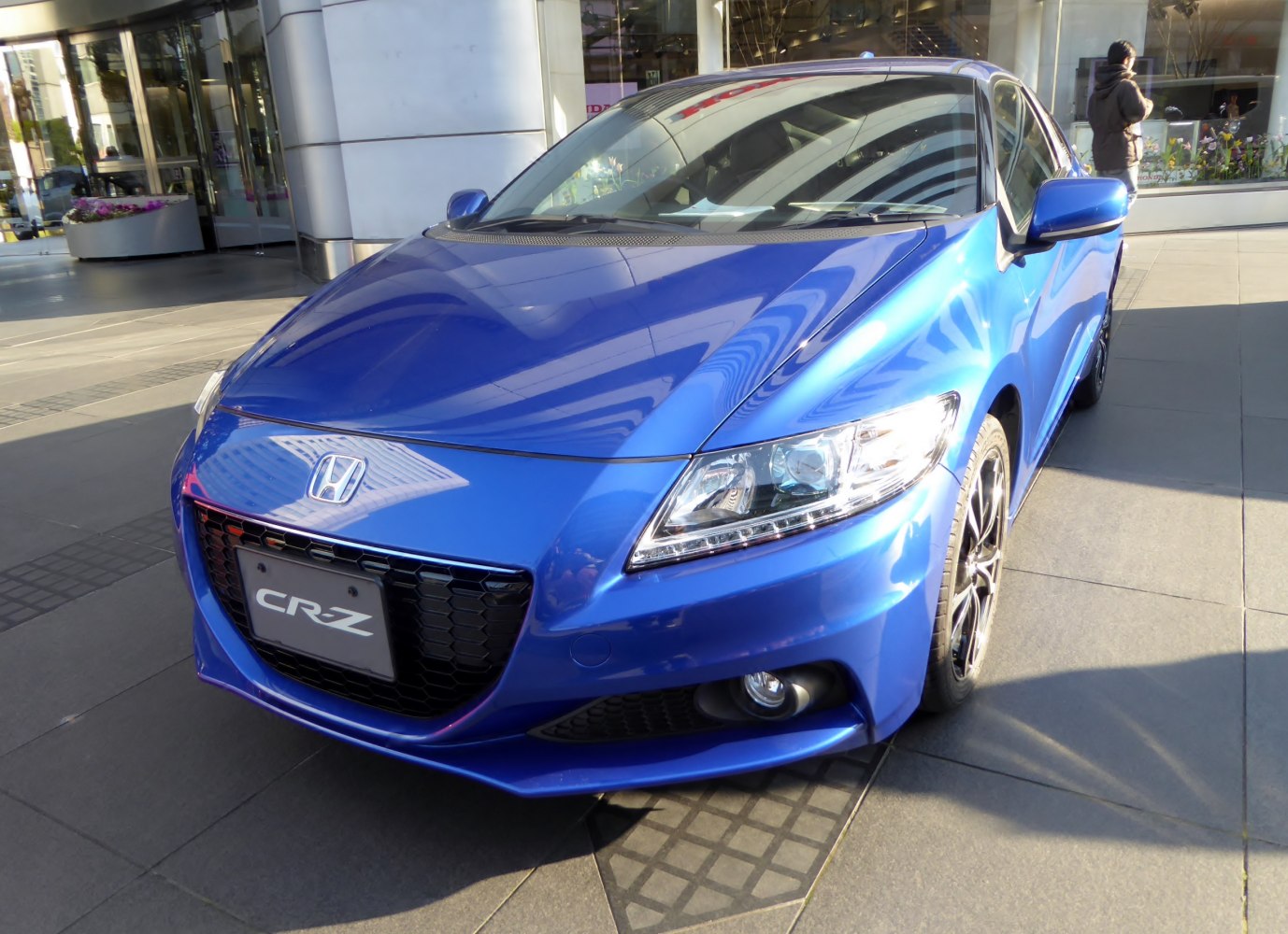 Front view with grille and headlights of a sleek blue car