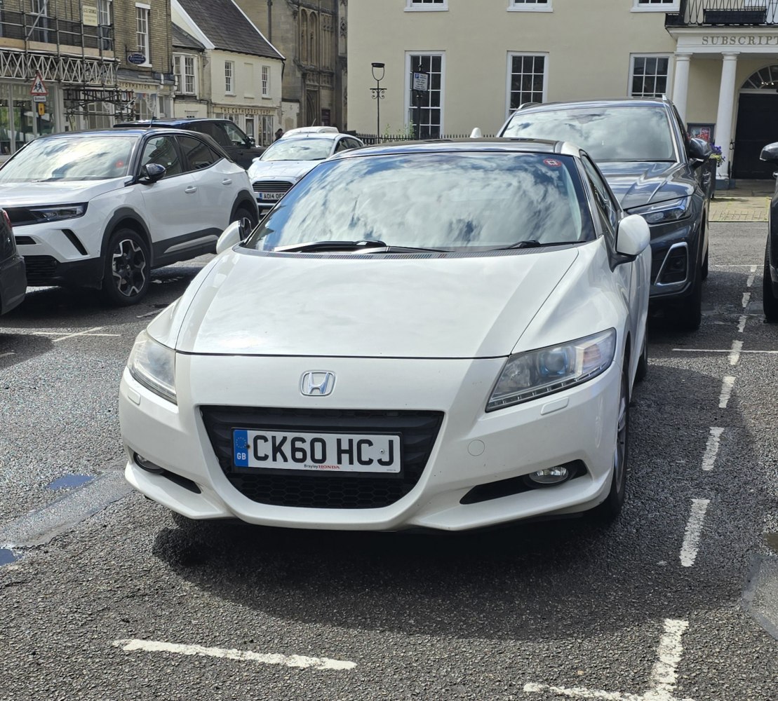Front view with sharp headlights and sporty grille