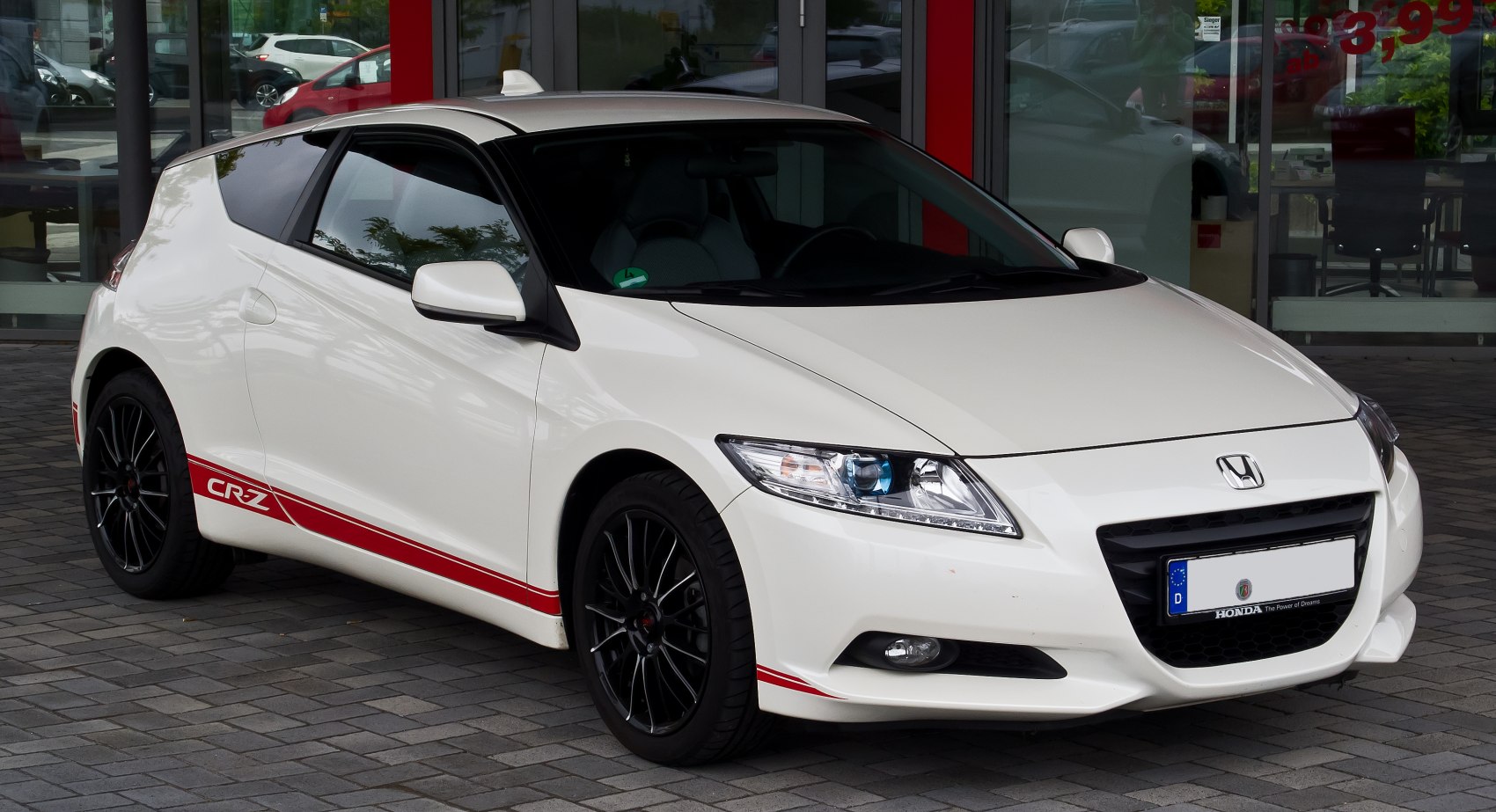 Sporty white coupe with black wheels and red stripes