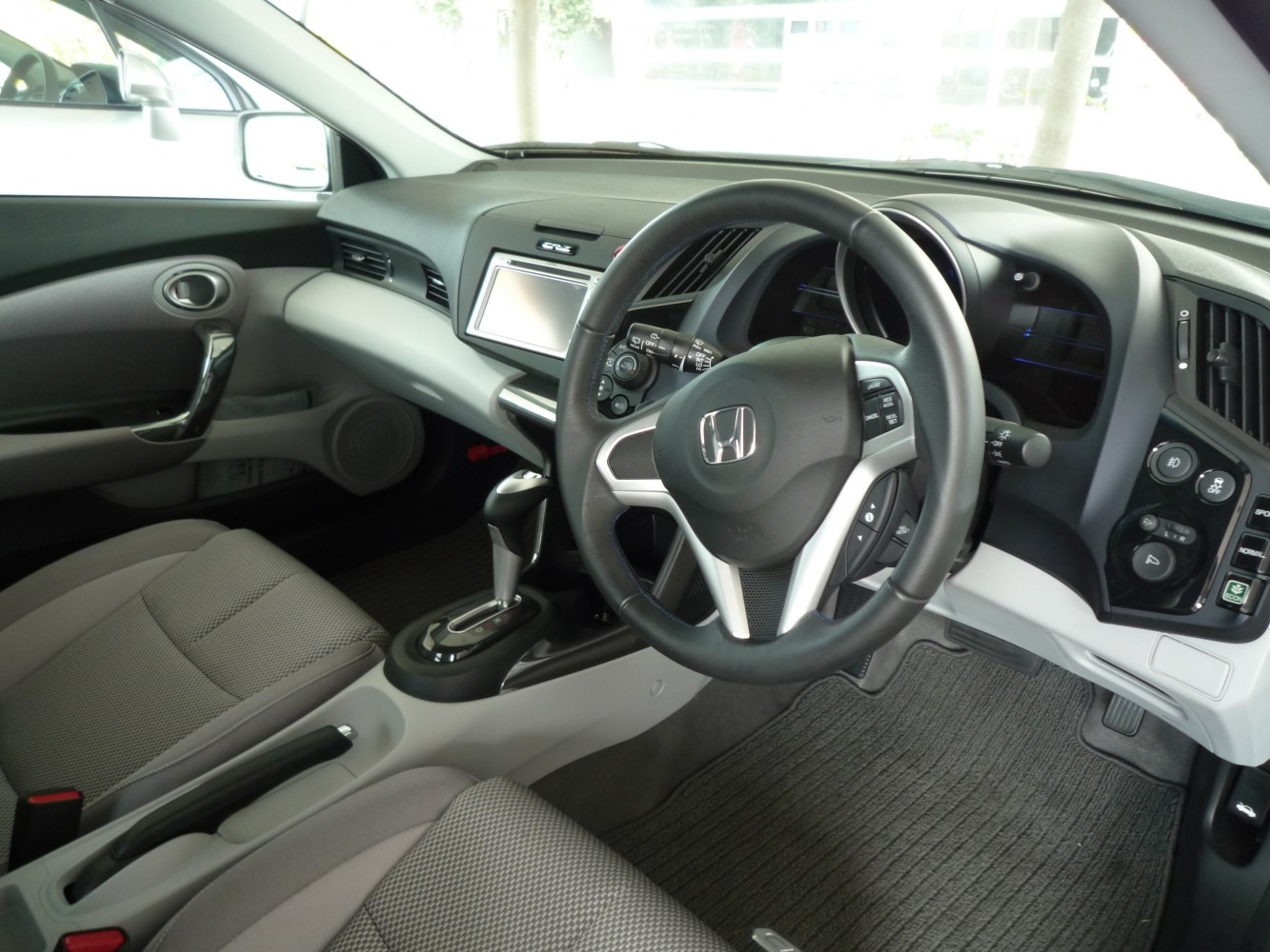 Interior dashboard, steering wheel, and center console of a compact hybrid vehicle