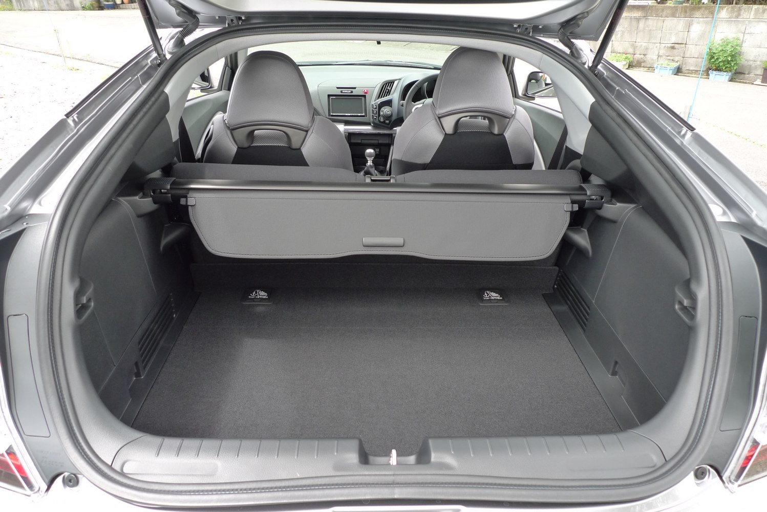 Hatchback trunk cargo space with rear seats and dashboard visible
