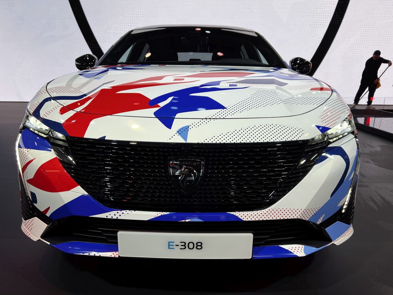 Front view with artistic wrap and black bold grille