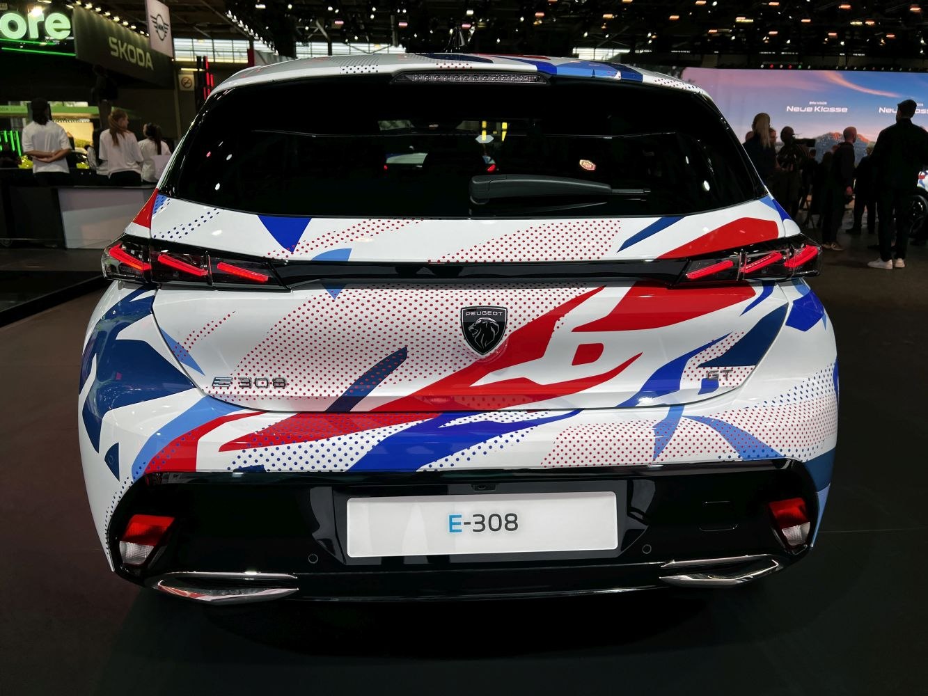 Rear view with E-308 badge and colorful abstract paint pattern.