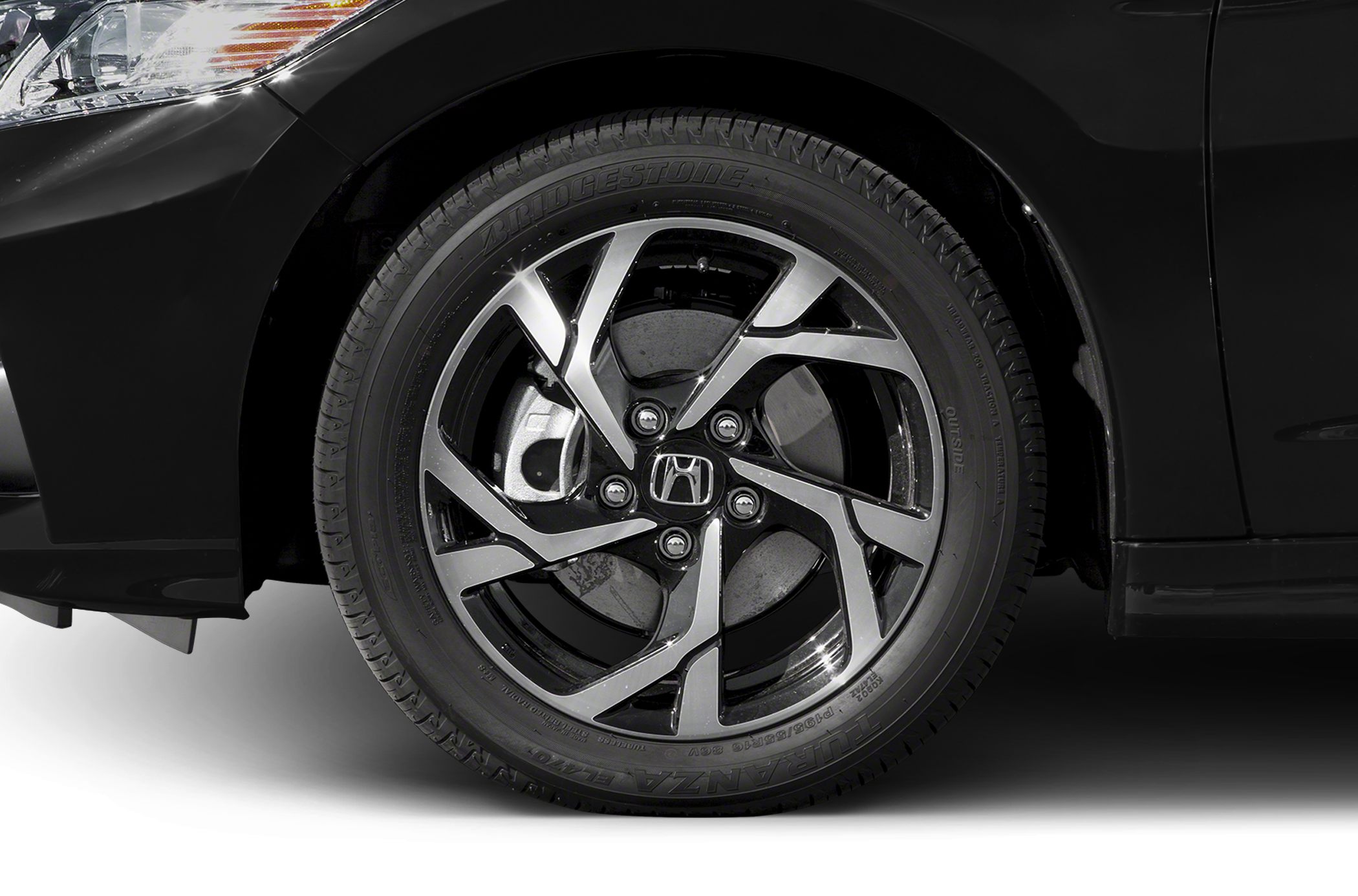 Alloy wheel and tire close-up with detailed spoke design and brake disc