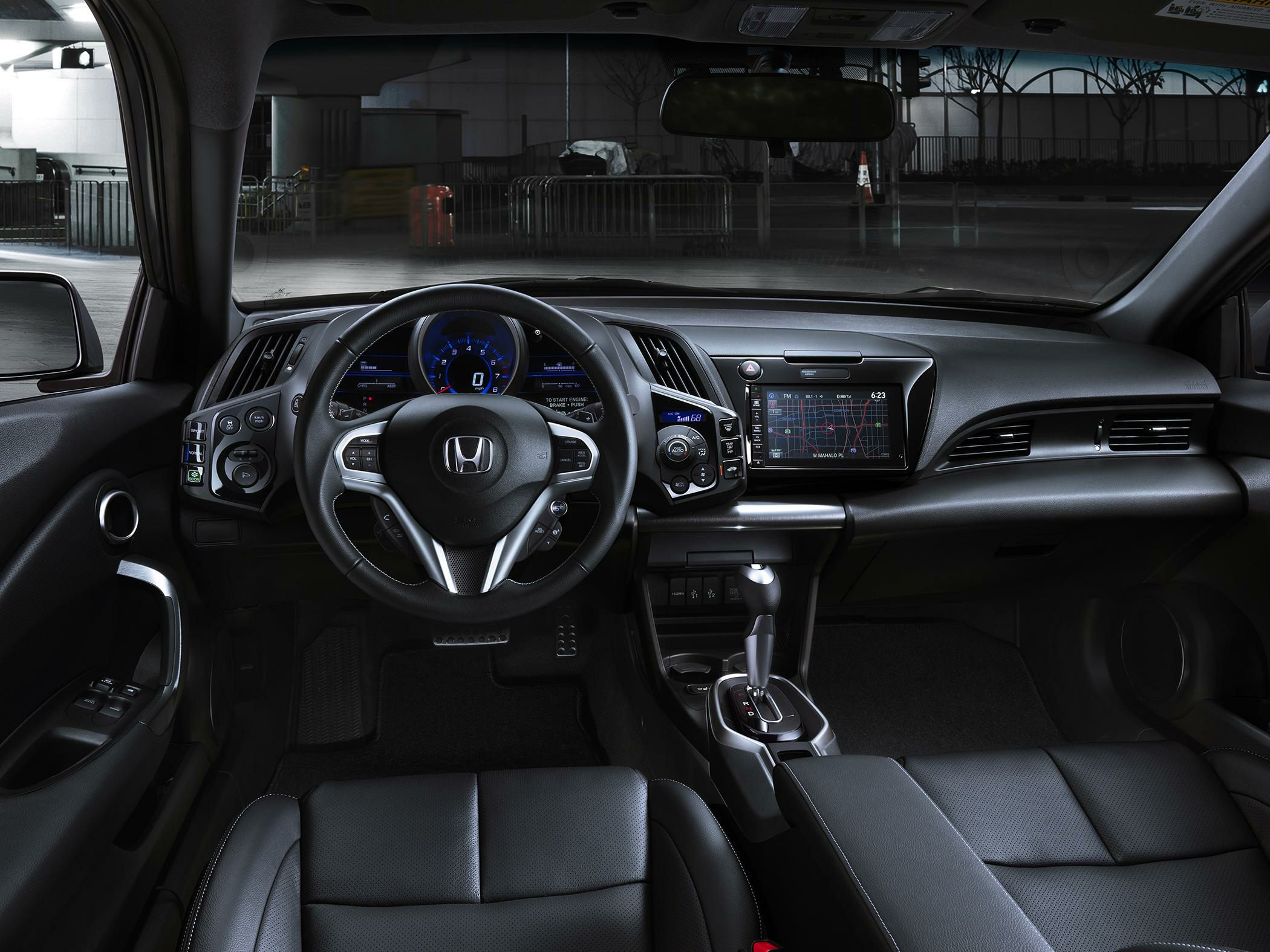 Interior view focusing on the steering wheel and dashboard with infotainment