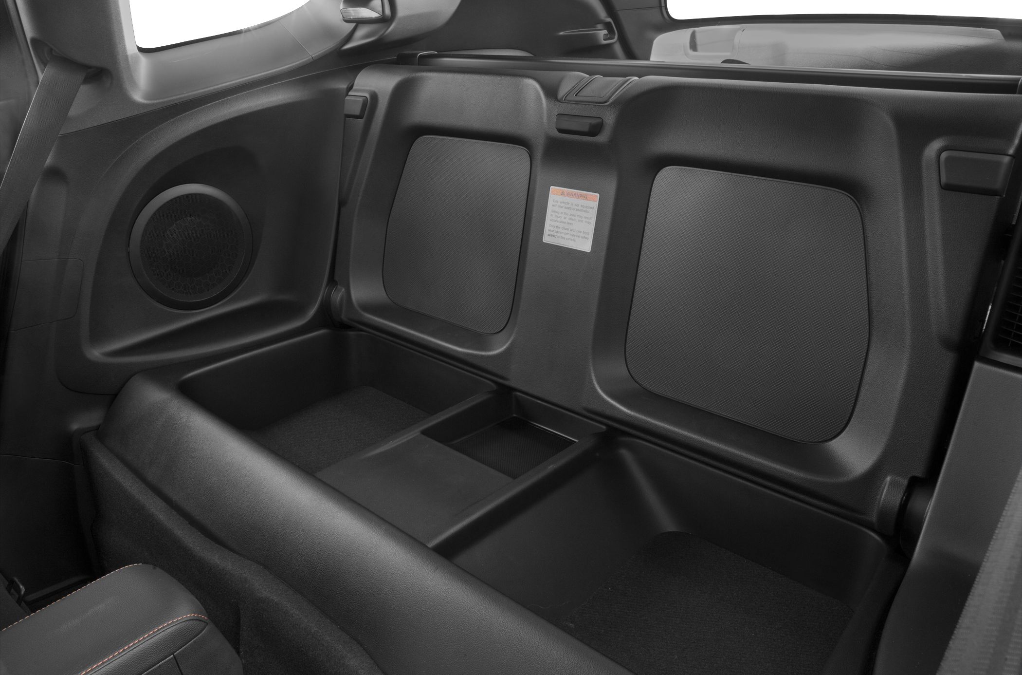 Rear storage compartment and speakers in compact hatchback interior