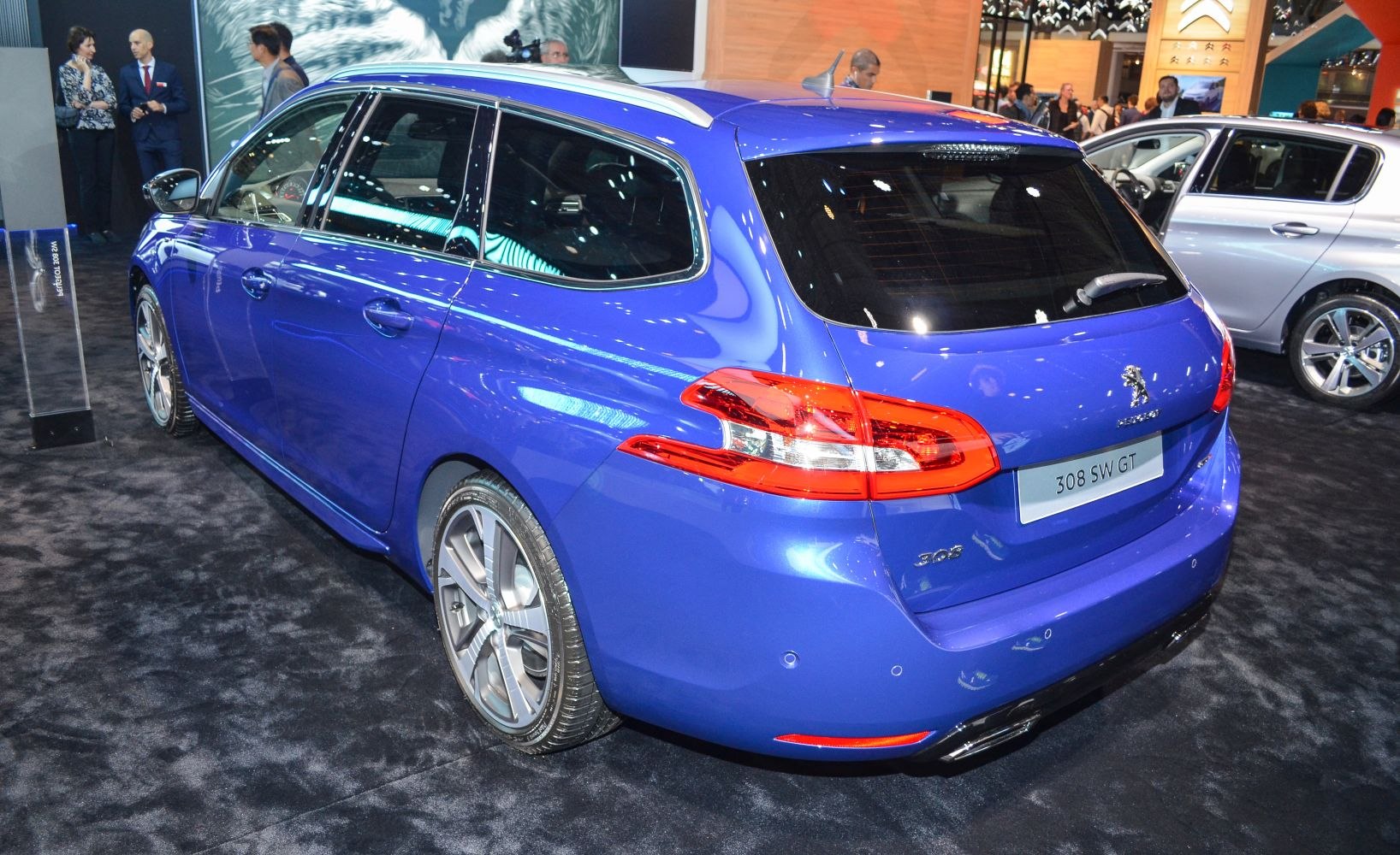 Rear and side view of a blue station wagon with sleek tail lights and alloy wheels