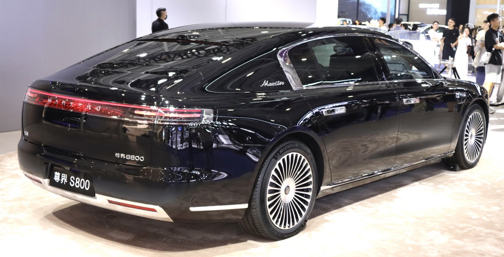 Sleek black sedan rear with LED tail lights and alloy wheels.